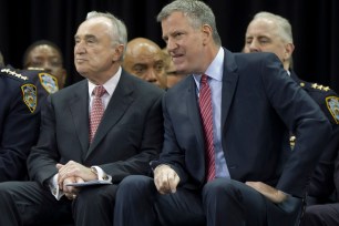 Mayor Bill de Blasio sits aside police Commissioner Bill Bratton at a Police Academy graduation ceremony on Dec. 29.