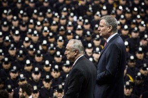 Commissioner Bill Bratton (left) and Mayor Bill de Blasio attend a NYPD graduation ceremony at Madison Square Garden on Dece. 29.