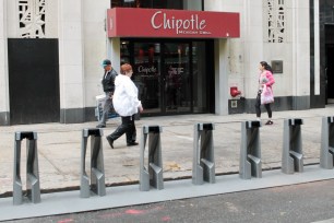 A worker at this Chipotle in downtown Brooklyn raised his hands in the anti-cop "Hands up, don't shoot" gesture when nine NYPD officers entered the restaurant on December 16.