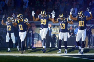 Five St. Louis Rams players took to the field on Sunday doing the "Hands Up, Don't Shoot" pose in support for Michael Brown.