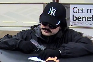 This comically mustachioed man robbed a bank in Nassau County on Monday.