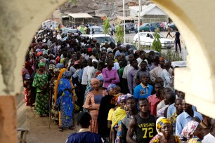 Nigerians lineup for accreditation before casting their votes in Yola, Nigeria.