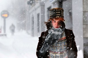 A man endures wind-whipped snow while walking through a winter storm in single digit temperatures in Portland, Maine.