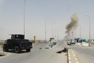 Smoke rises from a bomb attack in clashes between Iraqi security forces and Islamic State militants on the outskirts of Ramadi.