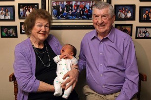 Leo and Ruth Zanger sit with their 100th grandchild, Jaxton Zanger