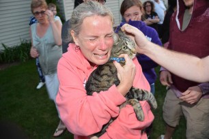 Roscoe's owner is overcome with joy after the cat was saved from a dried up well.