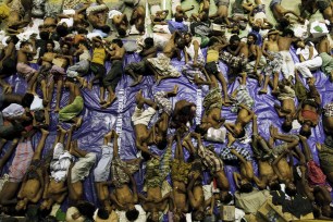 Migrants rest inside a shelter in Lhoksukon, Indonesia after they were rescued from boats.