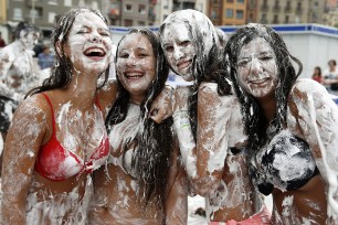 Young women take part in the fifth annual "Meringue War" at Zurriola beach in San Sebastian, Spain.