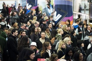 Evening commuters wait for New Jersey Transit trains at Penn Station