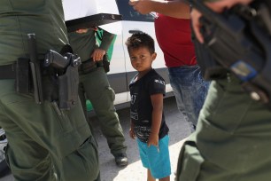 US Border Patrol agents take into custody a father and son from Honduras.