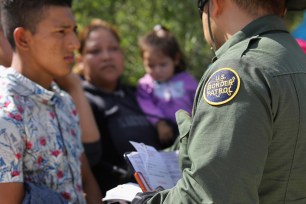 Border patrol agent and migrant