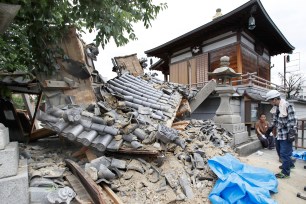 The gate of the Myotoku-ji temple collapsed after an earthquake hit Japan.