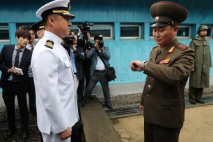 A North Korean military official looks at his watch.