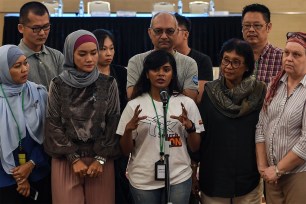 Grace Subathirai Nathan (center), daughter of missing Flight MH370 passenger Anne Daisy, speaks to the media.