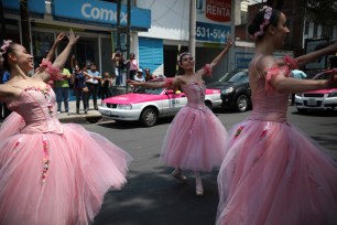 Ballerinas dance during a red traffic light, in Mexico City.