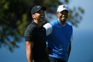 Jason Day and Tiger Woods share a laugh on the fourth hole during the first round of the Farmers Insurance Open in January.