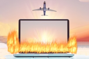 Laptop on fire with airplane overhead.