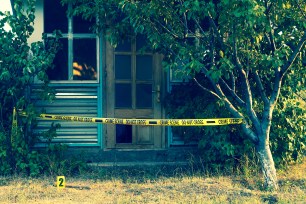 Crime scene tape in front a house