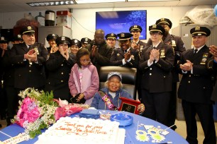 Onidii Noiis with her 10-year-old granddaughter, Kira Raylas, and police officers at her retirement party.