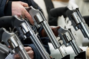 A visitor holding a revolver by US manufacturer Smith