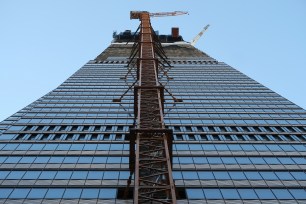 A construction crane rises on the side of One Vanderbilt on June 11.