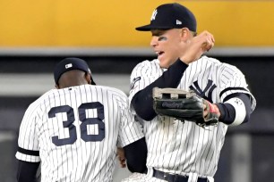 Aaron Judge celebrates with Cameron Maybin after the Yankees' 8-2 win in Game 2 of the ALDS on Saturday.