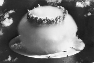 The 'Baker' blast of Operation CROSSROADS, detonated underwater, creates a Wilson condensation cloud, which hides all but the crown of a column of water the blast produced.