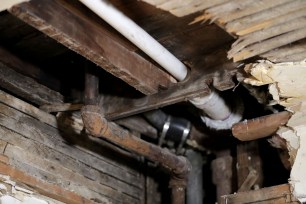 A lead pipe in a hole in the kitchen ceiling of a home in Newark, NJ.