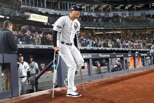 Dellin Betances walks out onto the field in crutches during players introductions before Game 1 of the ALDS.