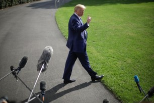 President Donald Trump walks across the South Lawn of the White House in Washington, Friday, Oct. 4, 2019, before boarding Marine One helicopter for the short trip to nearby Walter Reed National Military Medical Center in Bethesda, Md. (AP Photo/Pablo Martinez Monsivais)