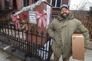 Bed Stuy inventor Bob James, aka “Uncle Bob”, next to his anti-package theft creation, called the “Bob box”, outside his home.