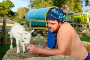 Mr February feeds a goat