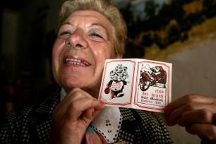 Bruna Bressan holds up a membership card to the 'Ugly Club' in the town of Piobbico, Italy.