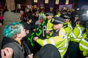 An Antifa group holds an Anti-Boris Johnson protest outside Downing Street and along Whitehall, clashing aggressively with The Metropolitan Police in London, England.