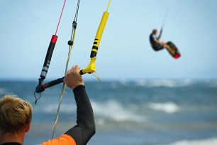 A man kite surfing on the beach