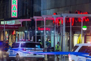 Workers putting up scaffolding at the building where the fatal accident took place.