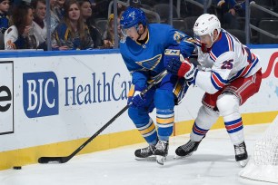 The Rangers' Libor Hajek pressures the Blues' Tyler Bozak.