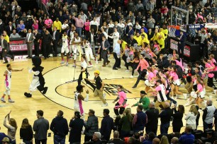 Providence fans start to storm the court at the end of their 74-71 upset win over No. 10 Seton Hall.