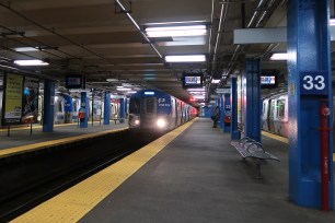 A train pulls into the 33rd Street PATH station