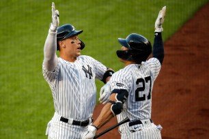 Aaron Judge (left) celebrates with Giancarlo Stanton