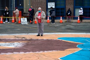 People wait in line to get tested for Covid-19 at the Ann Street School Testing Center in Newark, New Jersey.