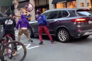 A still showing the bicyclists attacking the BMW