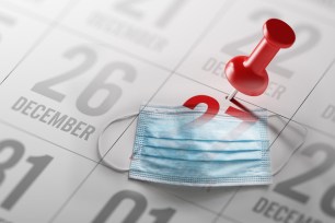 Photo illustration of December 27 written on a calendar to remind you an important appointment and a facemask.