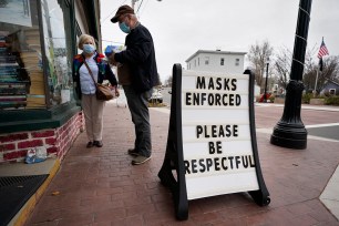 Shoppers comply with the mask regulations to help prevent the spread of the coronavirus in Bridgton, Maine.