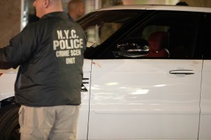 Police officers at the scene of a fatal shooting in Astoria, Queens.