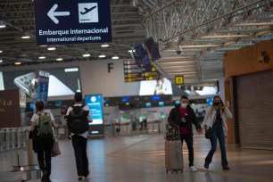 People walking in Galeao International airport in Rio de Janeiro, Brazil on April 13, 2021. Brazil is one of the listed as "Level 4: Do Not Travel" by the State Department.