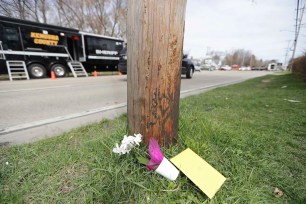 Flowers and a card are left near the scene of an early Sunday fatal shooting at Somers House Tavern in Kenosha, Wis., on Sunday, April 18 2021.