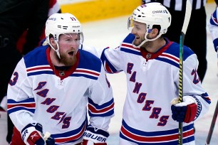 Alexis Lafrenière (left) celebrates his goal with teammate Anthony Bitetto.