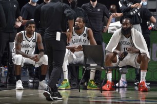 Kyrie Irving, Kevin Durant, and James Harden of the Brooklyn Nets huddle up