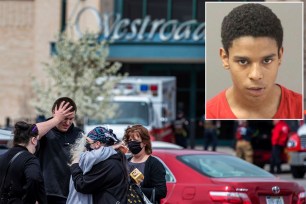 People hug in the parking lot after a shooting at Westroads Mall on Saturday, April 17, 2021 in Omaha, Neb.